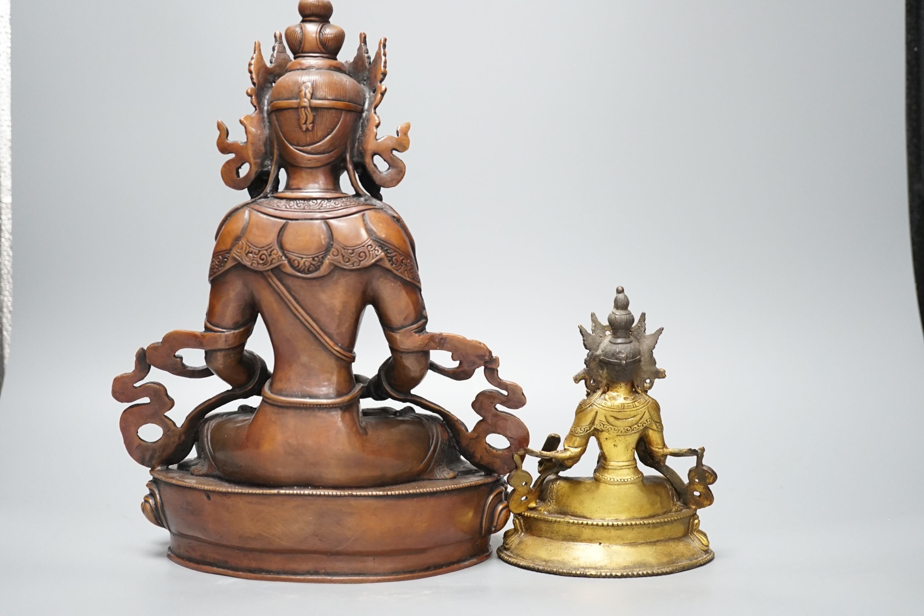 A Tibetan copper and brass ewer, together with a gilt-metal bodhisattva and another bronze bodhisattva, tallest 31cm